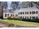 Classic home with black shutters, well-maintained lawn, mature shrubbery, and traditional design elements at 3508 Cambridge Rd, Durham, NC 27707