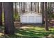 Detached three-car garage in a wooded area, offering ample parking and storage with a charming landscape at 3508 Cambridge Rd, Durham, NC 27707
