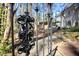 Ornate iron gate detail with glimpses of the home and backyard, inviting exploration at 3508 Cambridge Rd, Durham, NC 27707