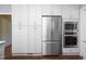 Modern kitchen featuring stainless steel appliances, white cabinets, and ample storage at 3508 Cambridge Rd, Durham, NC 27707