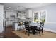 Open kitchen and dining area with modern white cabinets, granite countertops, and stylish lighting at 3508 Cambridge Rd, Durham, NC 27707