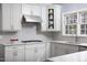 Well-lit kitchen featuring white cabinets, stainless steel appliances, and granite countertops at 3508 Cambridge Rd, Durham, NC 27707