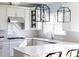 Modern kitchen with gray cabinets, granite countertops, stainless steel appliances, and decorative hanging lights at 3508 Cambridge Rd, Durham, NC 27707