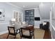 Comfortable living room featuring built-in shelves and ample natural light from large window at 3508 Cambridge Rd, Durham, NC 27707