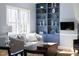Comfortable living room with custom shelving, bright natural light, and stylish decor at 3508 Cambridge Rd, Durham, NC 27707