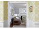 Open doorway with decorative wallpaper leading to an elegant living room with a fireplace and comfortable seating at 3508 Cambridge Rd, Durham, NC 27707