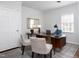 Bright home office with a modern desk, stylish seating, and a well-lit workspace at 3508 Cambridge Rd, Durham, NC 27707