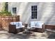 Outdoor patio with sofas and a brick wall with planters and a seating area at 3508 Cambridge Rd, Durham, NC 27707