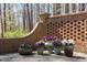Brick wall with multiple planters full of colorful purple and white flowers at 3508 Cambridge Rd, Durham, NC 27707