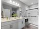 Modern bathroom with double sink vanity, stylish fixtures, and a glass-enclosed shower at 358 E Painted Way Way, Clayton, NC 27527