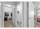 Hallway view of the half bath and walk-in closet at 358 E Painted Way Way, Clayton, NC 27527