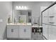 Bathroom with double sink vanity, framed mirror, and a glass-enclosed shower at 358 E Painted Way Way, Clayton, NC 27527