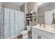 Well-lit bathroom with a shower/tub combo and stylish decorative elements at 358 E Painted Way Way, Clayton, NC 27527