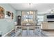 Inviting dining room with large table set for six with plenty of natural light at 358 E Painted Way Way, Clayton, NC 27527