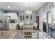 Dining area showcasing wood table with seating for six, and access to patio at 358 E Painted Way Way, Clayton, NC 27527