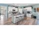 Bright kitchen featuring white cabinetry, stainless steel appliances, granite countertops and island seating at 358 E Painted Way Way, Clayton, NC 27527
