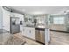 Open-concept kitchen with stainless steel appliances, granite countertops and breakfast bar seating at 358 E Painted Way Way, Clayton, NC 27527