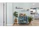 Stylishly decorated living area featuring a blue accent cabinet, floating shelves, and wood-look vinyl flooring at 358 E Painted Way Way, Clayton, NC 27527