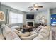Inviting living room with fireplace, large sectional and soft, natural light at 358 E Painted Way Way, Clayton, NC 27527