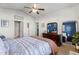 Bright bedroom featuring a bed with patterned bedding, wooden dresser, and large mirror at 358 E Painted Way Way, Clayton, NC 27527