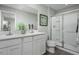 Modern bathroom with dual sinks, white cabinets, and a glass-enclosed shower for a spa-like experience at 359 Tormore Dr, Sanford, NC 27330