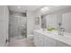 Bright bathroom with a double sink vanity, framed mirror, and glass enclosed shower stall at 37 Artesa Ct, Fuquay Varina, NC 27526