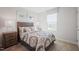 Bedroom featuring a decorative bedspread, a rustic bedside table, and natural light from a window at 37 Artesa Ct, Fuquay Varina, NC 27526