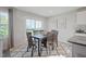 Bright dining area with natural lighting, and an adjacent kitchen with stainless appliances at 37 Artesa Ct, Fuquay Varina, NC 27526
