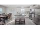 Beautiful kitchen featuring white cabinetry, stainless appliances, island, and adjacent dining area at 37 Artesa Ct, Fuquay Varina, NC 27526