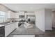 Modern kitchen featuring white cabinets, granite countertops, and stainless steel appliances at 37 Artesa Ct, Fuquay Varina, NC 27526