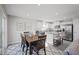 Bright open kitchen with stainless appliances, kitchen island, and adjacent dining area at 37 Artesa Ct, Fuquay Varina, NC 27526