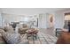 Open concept living space with neutral furniture, view into modern kitchen, and natural lighting at 37 Artesa Ct, Fuquay Varina, NC 27526