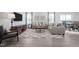 Open concept living room showcasing neutral furniture, area rug, and mounted television at 37 Artesa Ct, Fuquay Varina, NC 27526