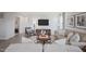 Cozy living room featuring neutral furniture, area rug, and mounted television at 37 Artesa Ct, Fuquay Varina, NC 27526