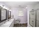 Well-lit bathroom featuring dual sinks, decorative mirrors, and a walk-in shower at 45 Wimberly Ave, Rocky Mount, NC 27804