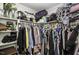 Walk in closet with shelving and hanging racks filled with various folded and hanging clothes at 45 Wimberly Ave, Rocky Mount, NC 27804