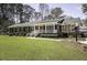 Beautifully landscaped front yard with a charming brick home and covered porch at 45 Wimberly Ave, Rocky Mount, NC 27804