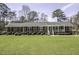 Charming brick home with a well-manicured lawn, mature trees, and inviting front porch at 45 Wimberly Ave, Rocky Mount, NC 27804