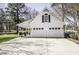Two-car garage with white doors and an attached carport on a sunny day at 45 Wimberly Ave, Rocky Mount, NC 27804