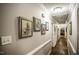 Hallway featuring hardwood floors, detailed trim, and a series of framed photos at 45 Wimberly Ave, Rocky Mount, NC 27804