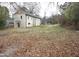 View of the large backyard with sparse grass and fallen leaves at 464 Longfellow St, Fuquay Varina, NC 27526
