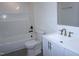 Bright bathroom featuring a shower-tub combo with white subway tiles and a white vanity with a modern faucet at 464 Longfellow St, Fuquay Varina, NC 27526