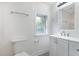 Light-filled half bath features white vanity, modern fixtures, and natural light from window at 464 Longfellow St, Fuquay Varina, NC 27526