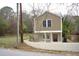 Unique two-story home with tan siding and a charming red front door at 464 Longfellow St, Fuquay Varina, NC 27526