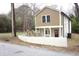 Inviting two-story home with tan siding and a charming red front door at 464 Longfellow St, Fuquay Varina, NC 27526