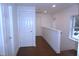Hallway with hardwood floors, white walls, recessed lighting, and view of doors and windows at 464 Longfellow St, Fuquay Varina, NC 27526