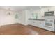 Bright, airy kitchen featuring white cabinets, updated appliances, and sleek flooring at 464 Longfellow St, Fuquay Varina, NC 27526