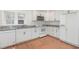 Modern kitchen with white cabinets, granite countertops, and stainless steel appliances at 464 Longfellow St, Fuquay Varina, NC 27526