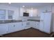 Bright eat-in kitchen featuring white cabinets, stainless steel microwave, and granite countertops at 464 Longfellow St, Fuquay Varina, NC 27526