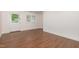 Bright living area featuring new flooring, fresh white paint, a door and large window at 464 Longfellow St, Fuquay Varina, NC 27526